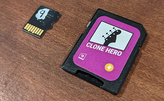 An SD card adapter next to the MicroSD card showing the same number on both